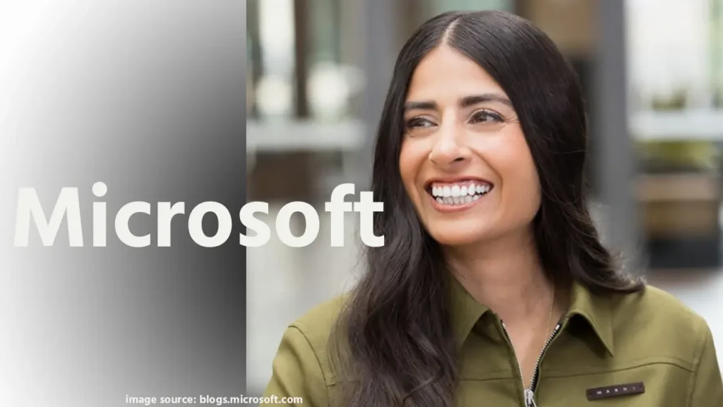 माइक्रोसॉफ्ट गेमिंग के नए सीईओ AshaSharma की आधिकारिक तस्वीर, जिसमें वे कॉर्पोरेट सूट में कॉन्फिडेंट मुस्कान के साथ Xbox लोगो बैकग्राउंड पर खड़ी हैं। यह भारतीय मूल की लीडर की नियुक्ति का प्रतीकात्मक चित्रण है, जो गेमिंग उद्योग में क्रांति लाने वाली हैं।