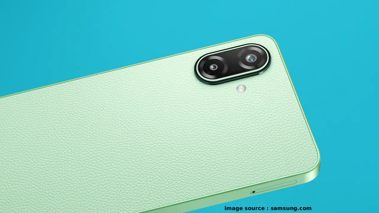 Android smartphone with a large 6.7-inch display, slim bezels, and a rear camera module on the back, showing Samsung Galaxy F70e 5G in a vibrant green or blue colour variant on a plain background.